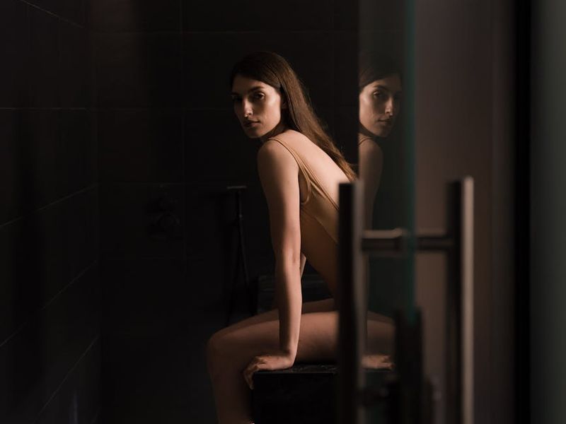 A person sitting calmly in a well-lit room, suggesting a state of focus.