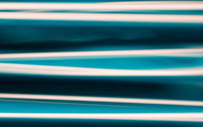 Abstract flowing lines with an aquamarine glow.